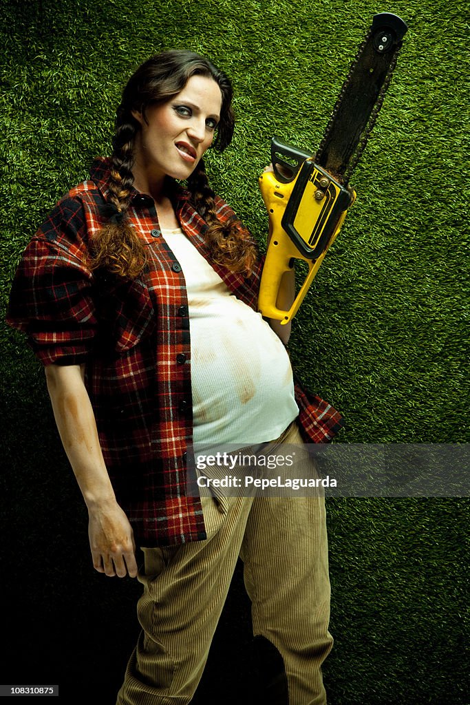 Nerd pregnant lumberjack holding a chainsaw