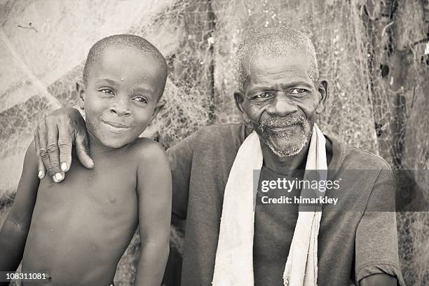 african grandfather and grandson - liberian culture stock pictures, royalty-free photos & images