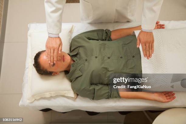 doctor's hands hovering over patient - hovering stock pictures, royalty-free photos & images