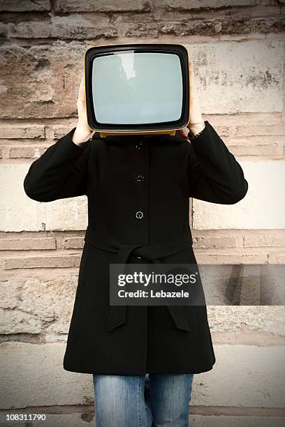 tv. in hand - carrying tv stock pictures, royalty-free photos & images