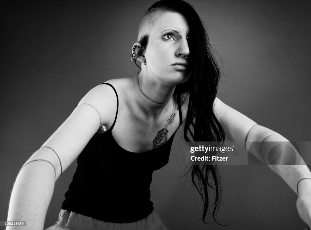 Funky beautiful gothic woman with undercut, indoor portrait