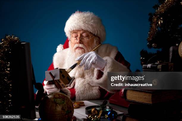 pictures of real santa claus working late - santas workshop stock pictures, royalty-free photos & images