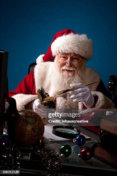 pictures of real santa claus working late - santas workshop stock pictures, royalty-free photos & images