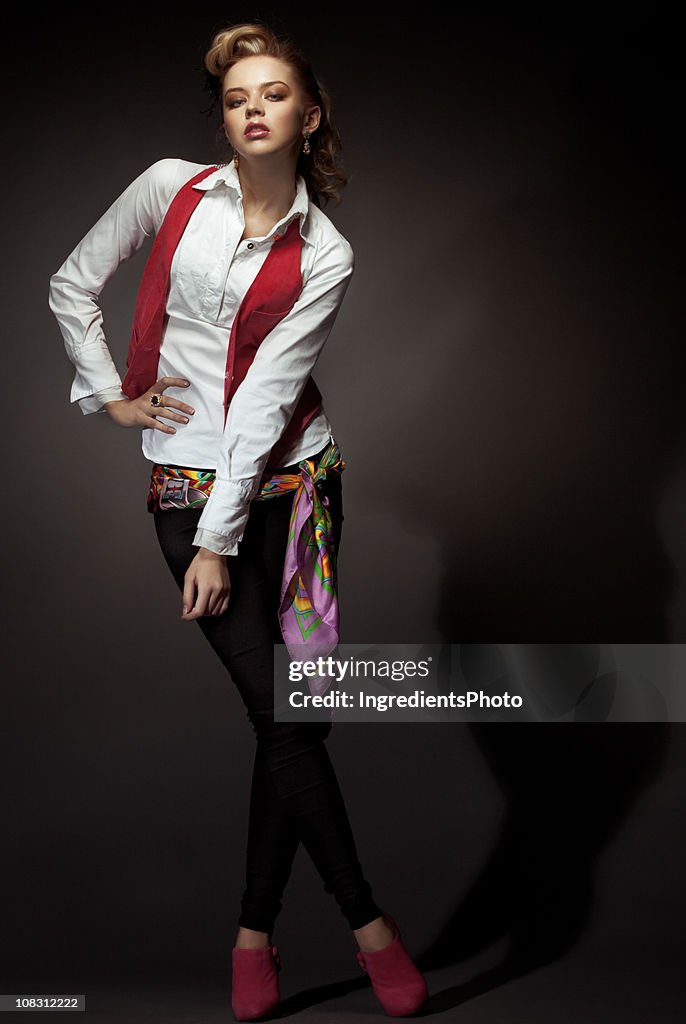 Expressive fashion portrait of young woman on dark background