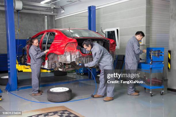 chinese mechanics working in garage - disassembling stock pictures, royalty-free photos & images