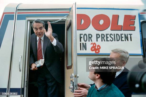 Republican presidential candidate Robert Dole waves as he boards his campaign's mini-bus on February 3, 1988 after finishing a stump speech in...