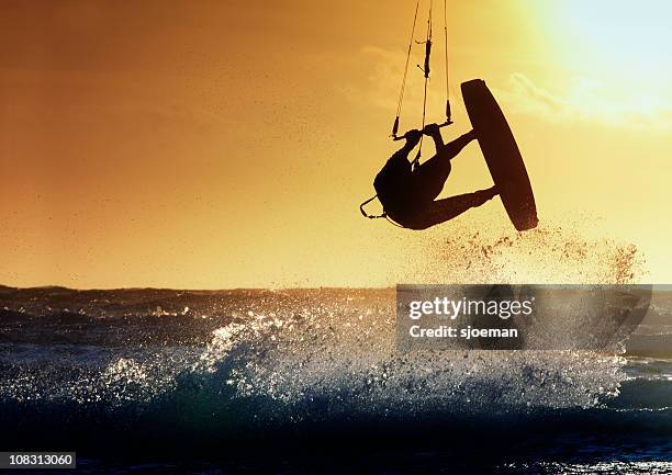 kite surfer in action - kite surfing stock pictures, royalty-free photos & images