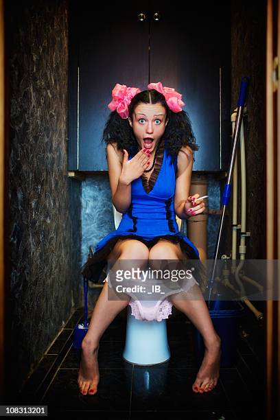 young girl secretly smoking in toilet. but someone saw her - peeking over stock pictures, royalty-free photos & images