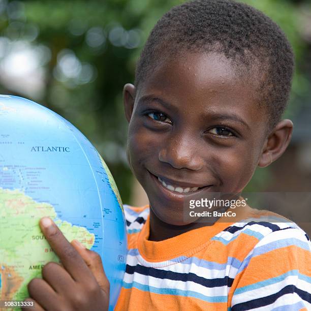 suriname, pointing at a globe. - gazon stock pictures, royalty-free photos & images