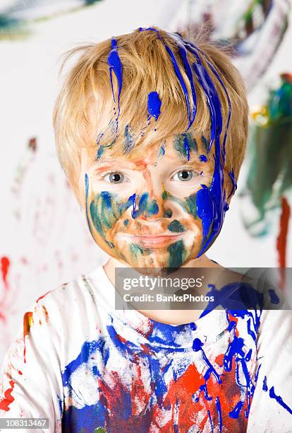 boy covered with paint - faces aftermath of storm eleanor stockfoto's en -beelden