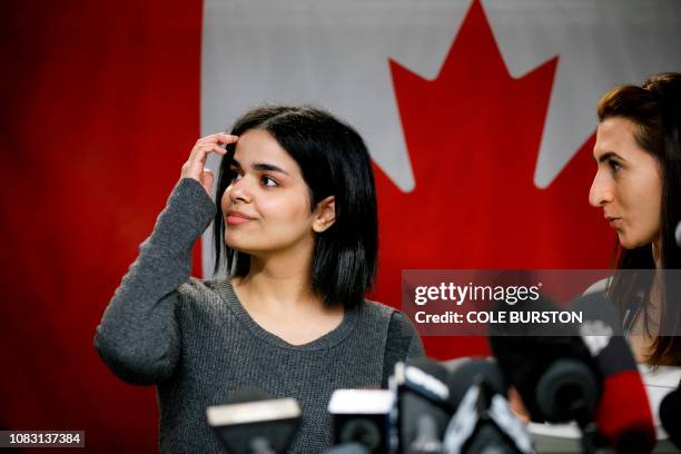 Rahaf Mohammed al-Qunun smiles as she addresses the media with the help of translator Saba Abbas during a press conference in Toronto at the offices...