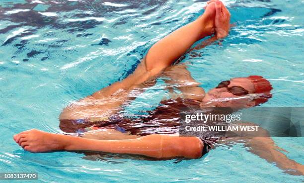 Synchronised swimmer from England surfaces during a training session at the National Aquatics Center 06 September one of the venues of the XVI...