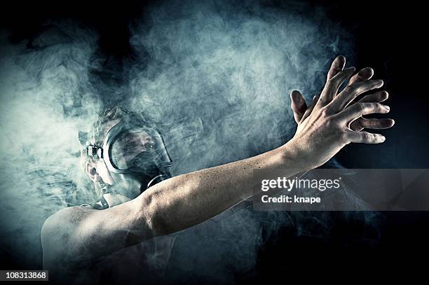 man reaching out wearing a gasmask - chemical warfare stock pictures, royalty-free photos & images