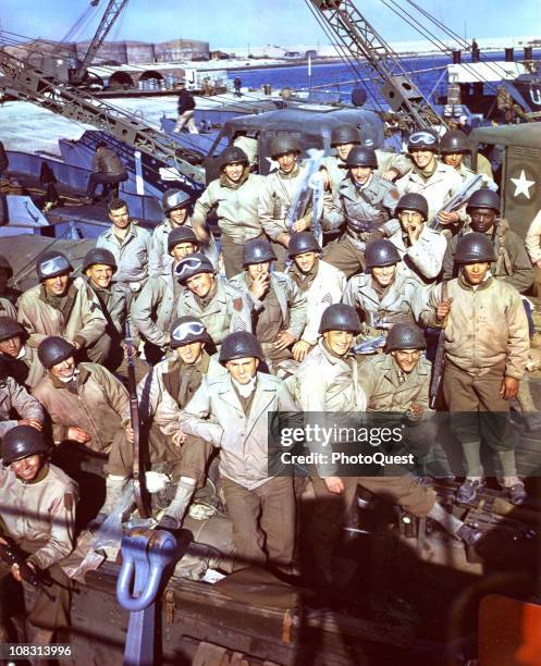 In England, American soldiers, having loaded their equipment and supplies onto an LCT await the signal to begin the D-Day invasion, June 1944.