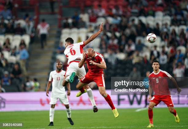 Saeed Murjan of Jordan and Mohammed Bassim of Palestine challenging for the ball during Palestine v Jordan, AFC Asian Cup football, Mohammed Bin...