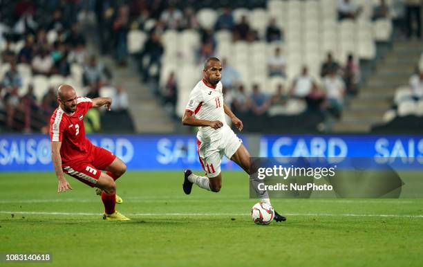 Yaseen Al-Bakhit of Jordan going past Mohammed Bassim of Palestine during Palestine v Jordan, AFC Asian Cup football, Mohammed Bin Zayed Stadium, Abu...