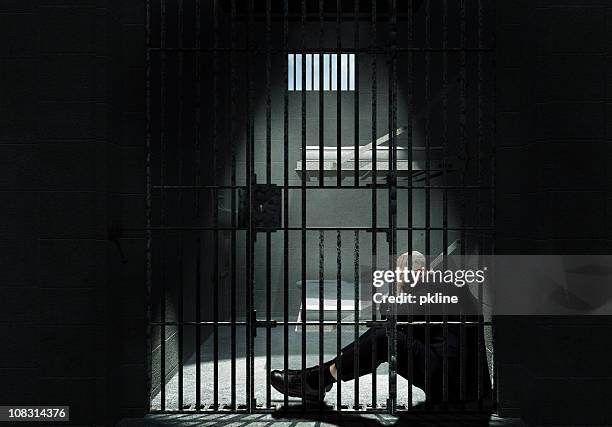 businessman sitting in jail - prison stock pictures, royalty-free photos & images