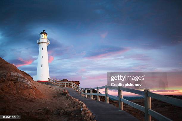 sunrise in castlepoint, new zealand - new zealand beach stock pictures, royalty-free photos & images