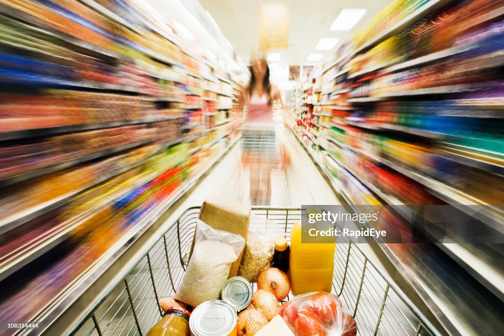 Shopping cart races through store with rainbow motion blur surrounding