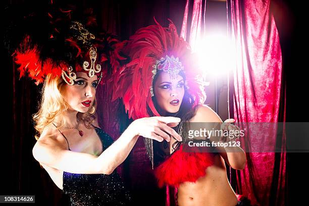 two showgirls on stage, pointing to right - burlesque stock pictures, royalty-free photos & images
