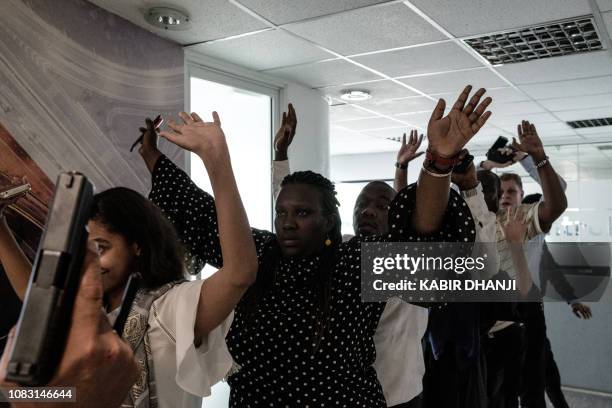 People are evacuated from a building after a bomb blast from the office block attached to the DusitD2 hotel in Nairobi, Kenya, on January 15, 2019. A...