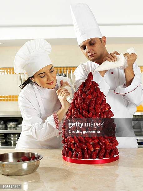 Cozinheiros Criar Pirmide De Morango Na Cozinha Industrial, Foto de stock