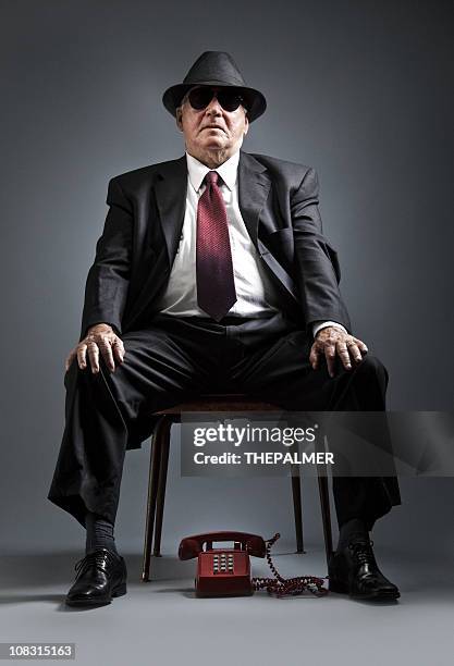 elegant senior man waiting for a phone call - bossy man stock pictures, royalty-free photos & images