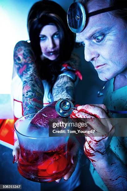 heart transplant - evil doctor stock pictures, royalty-free photos & images