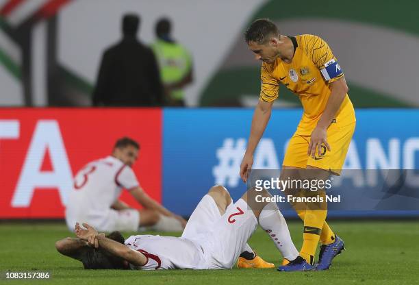 Mark Milligan of Australia consoles Ahmed Al Saleh of Syria during the AFC Asian Cup Group B match between Australia and Syria at Khalifa Bin Zayed...