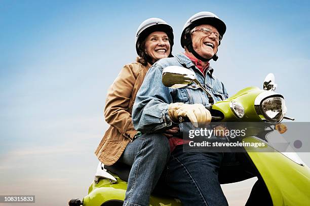 happy active senior couple on scooter - motorcycle live stock pictures, royalty-free photos & images
