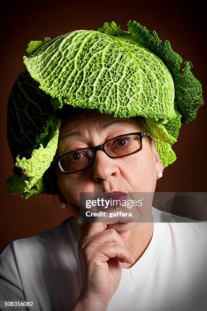 woman with cabbage hat - savoykål bildbanksfoton och bilder