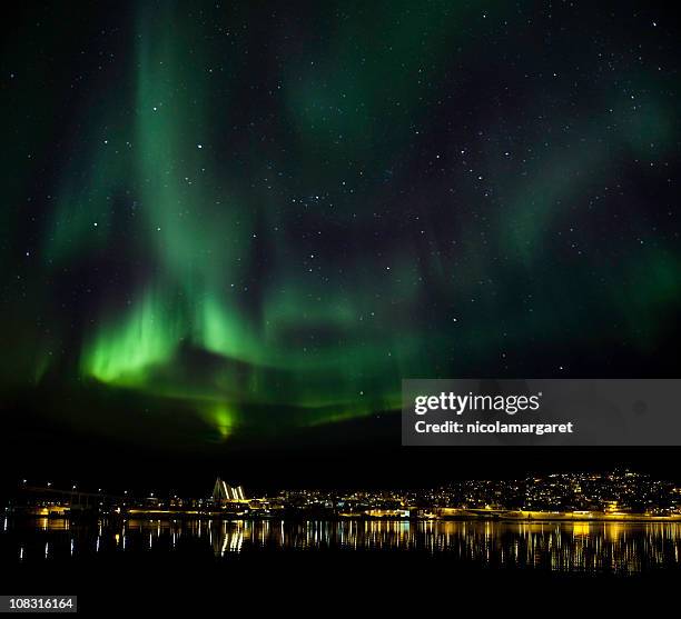 aurora borealis above tromso, norway - norway city stock pictures, royalty-free photos & images