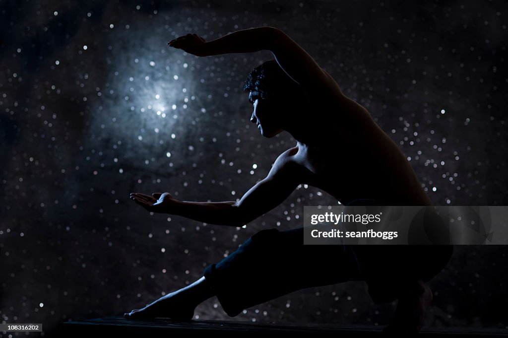 Tai chi man against starry sky at night