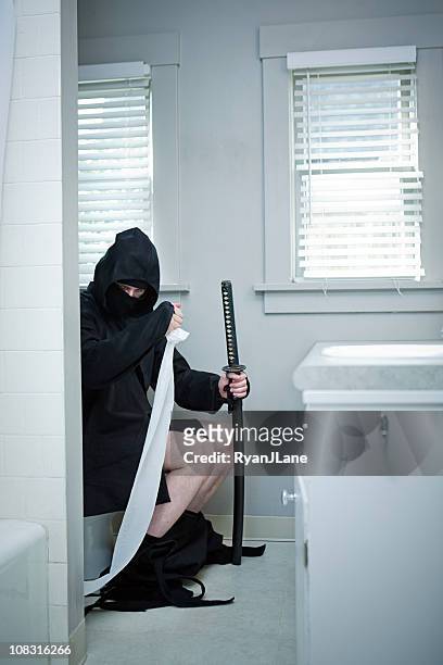 domestic ninja on the toilet - samurai sword stock pictures, royalty-free photos & images
