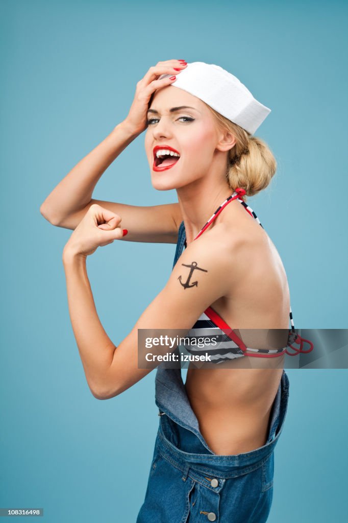 Pin-up style sailor woman flexing her arm