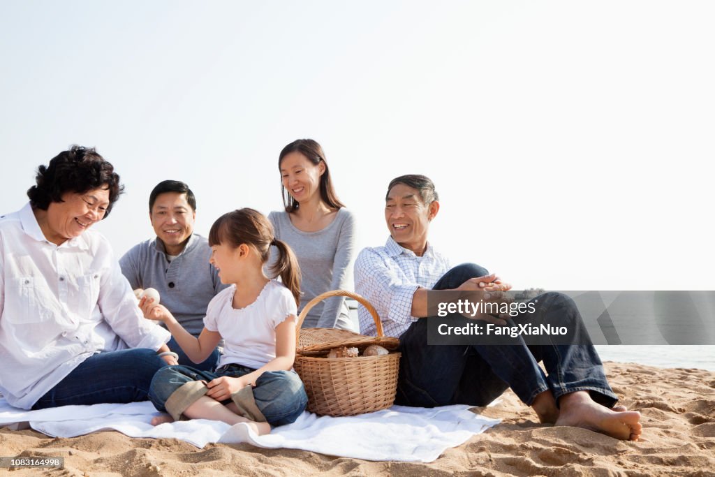Chinese family having picnic on beach