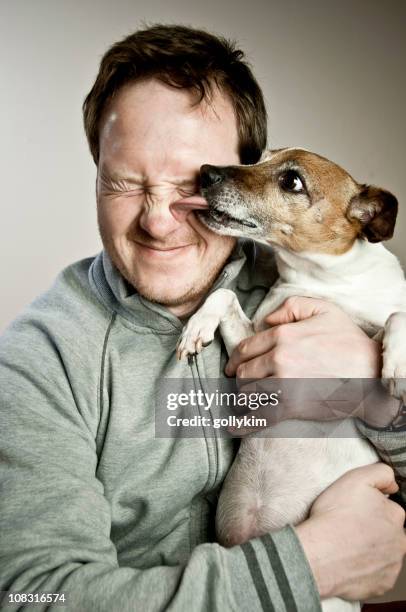 dog licking man's face - dog kiss stock pictures, royalty-free photos & images