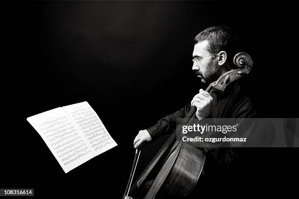 man playing cello - cellist stock pictures, royalty-free photos & images