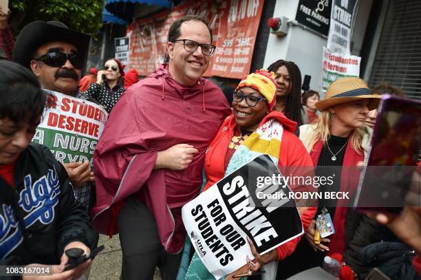 Public school teacher Ali Pettaway poses for a photo with United Teachers Los Angeles union President Alex Caputo-Pearl at a rally by striking...