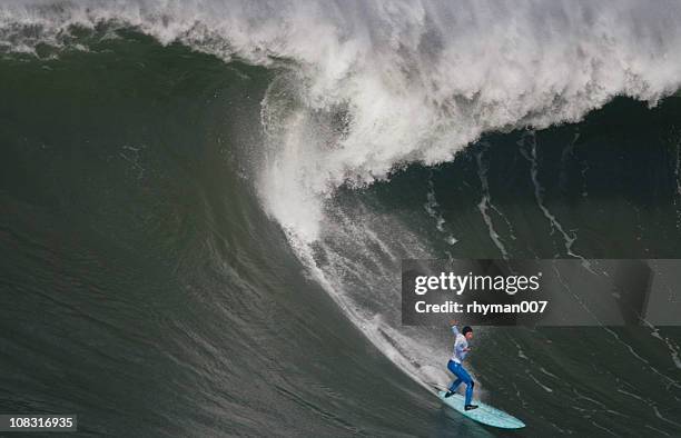 surfing the curl of a huge wave - big wave surfing stock pictures, royalty-free photos & images