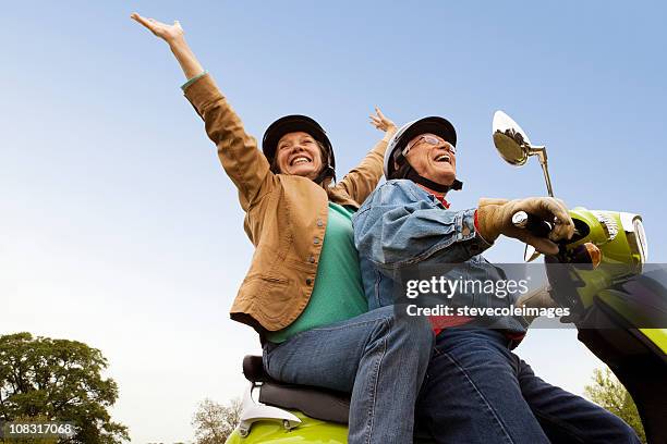 senior couple riding scooter - old motorcycles bildbanksfoton och bilder