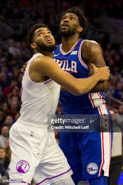 Karl-Anthony Towns of the Minnesota Timberwolves boxes out Joel Embiid of the Philadelphia 76ers in the first quarter at the Wells Fargo Center on...
