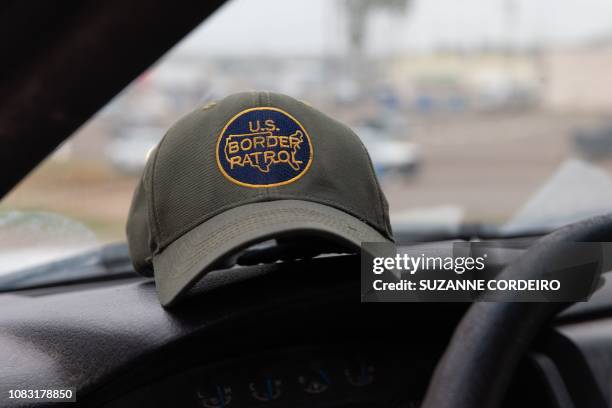 This photo shows a US Border Patrol hat sitting on dashboard of a Customs and Border Protection vehicle in McAllen, Texas, on January 15, 2019.