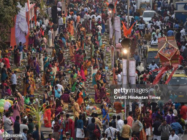 Hindu devotees cook traditional sweet dish on open fires during a community function on the occasion of Pongal at Dharavi on January 15, 2019 in...