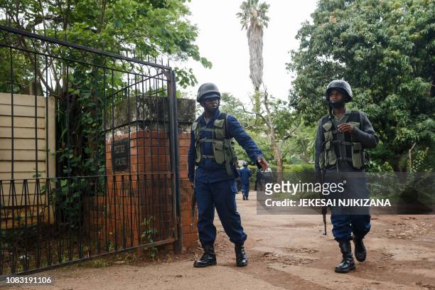 Zimbabwean policemen arrive at the home of Zimbabwean cleric and activist Evan Mawarire on January 16 in Avondale, Harare. - Leading Zimbabwean...