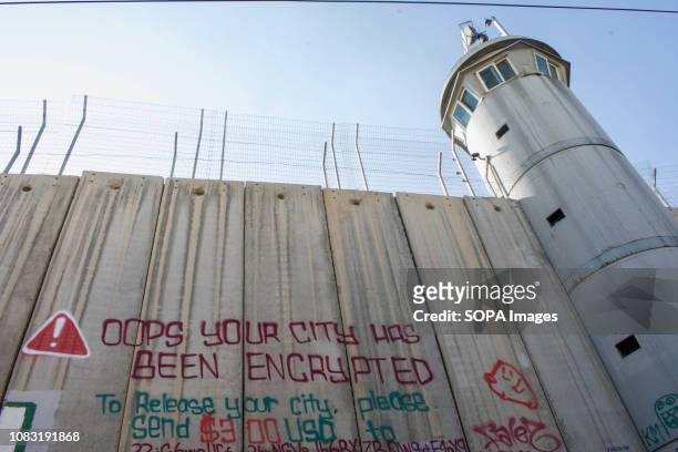 Watch tower and graffiti seen on the West Bank Separation Wall. The Israeli Separation Wall is a dividing barrier that separates the West Bank from...