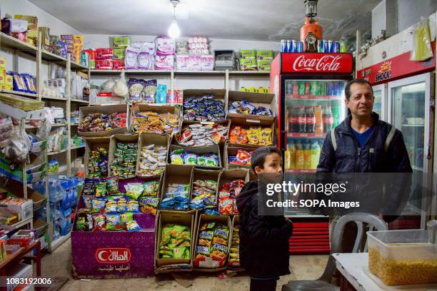 Palestinian refugees are seen in a shop at the Dheisheh refugee camp.