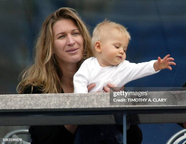 Steffi Graf and her son Jaden Gil watch as Andre Aggasi plays against Ramon Delgado of Paraguay at the 2002 US Open Tennis Tournament 31 August, 2002...