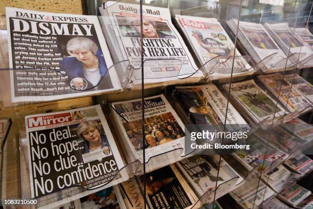 National and international newspapers, featuring front page reaction to the historic loss in the Brexit deal vote, sit on on a newsstand in London,...