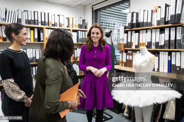 Britain's Catherine, Duchess of Cambridge, talks with Head of Costume Fay Fullerton in the pattern room during a visit to the costume department at...